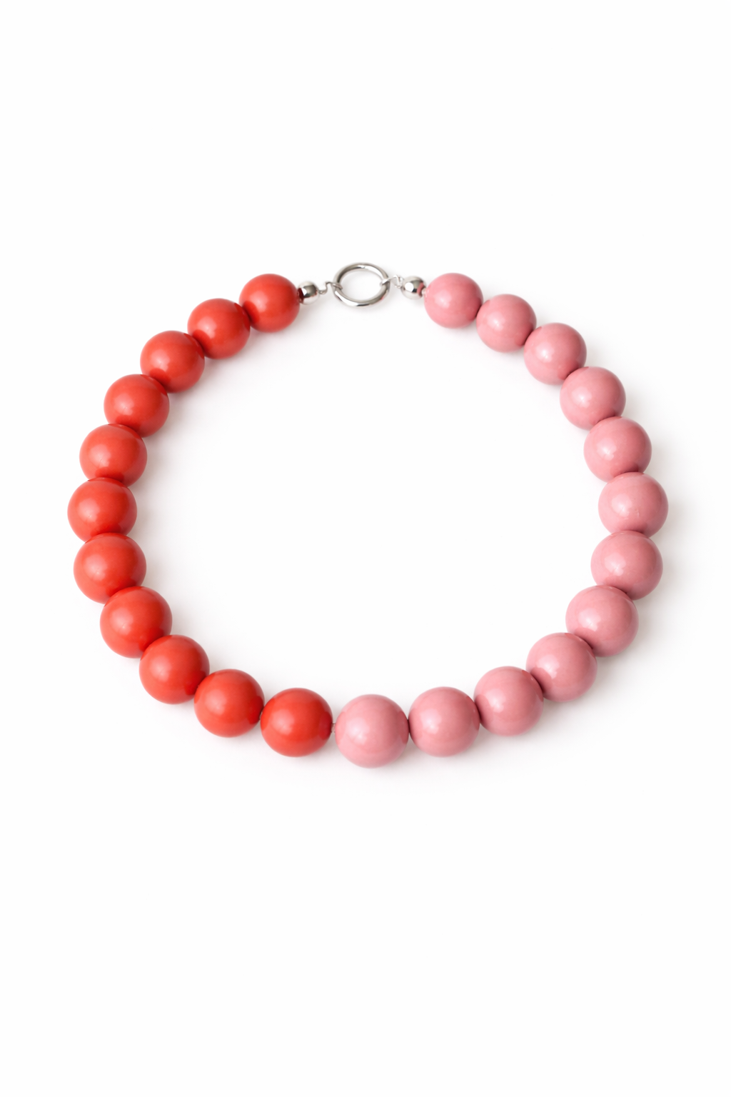 Necklace with pink and red beads on a white background
